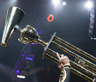 Cheerleader holding champion trophy at NCA All Star Nationals