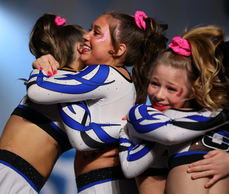 All star cheerleaders hugging