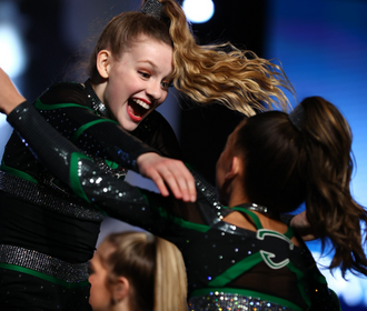 All star cheerleaders hugging