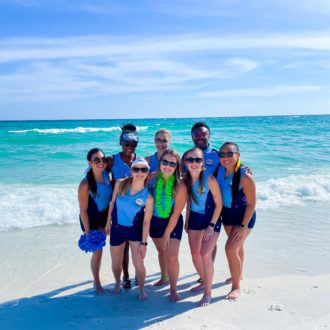 uca staff members posing at the beach during the pcb resort camp